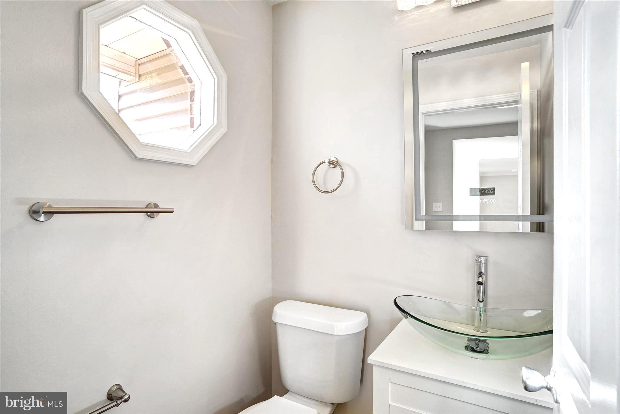 1324 Rock Chapel Road Herndon, VA 20170 - Photo 19 of 42 a bathroom with a toilet a sink and mirror