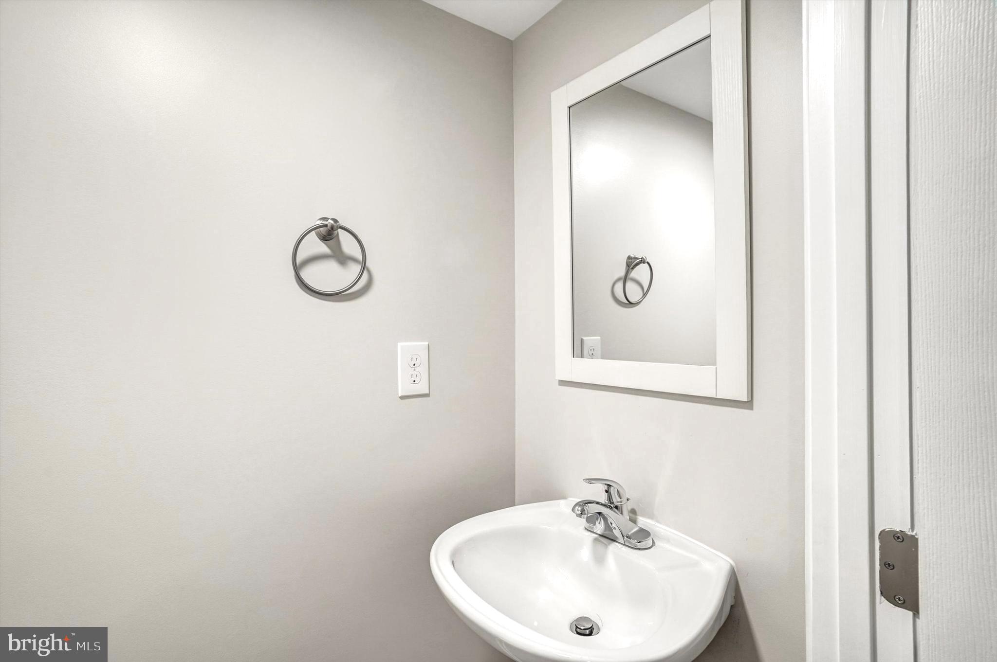 1324 Rock Chapel Road Herndon, VA 20170 - Photo 32 of 42 a bathroom with a sink and a mirror