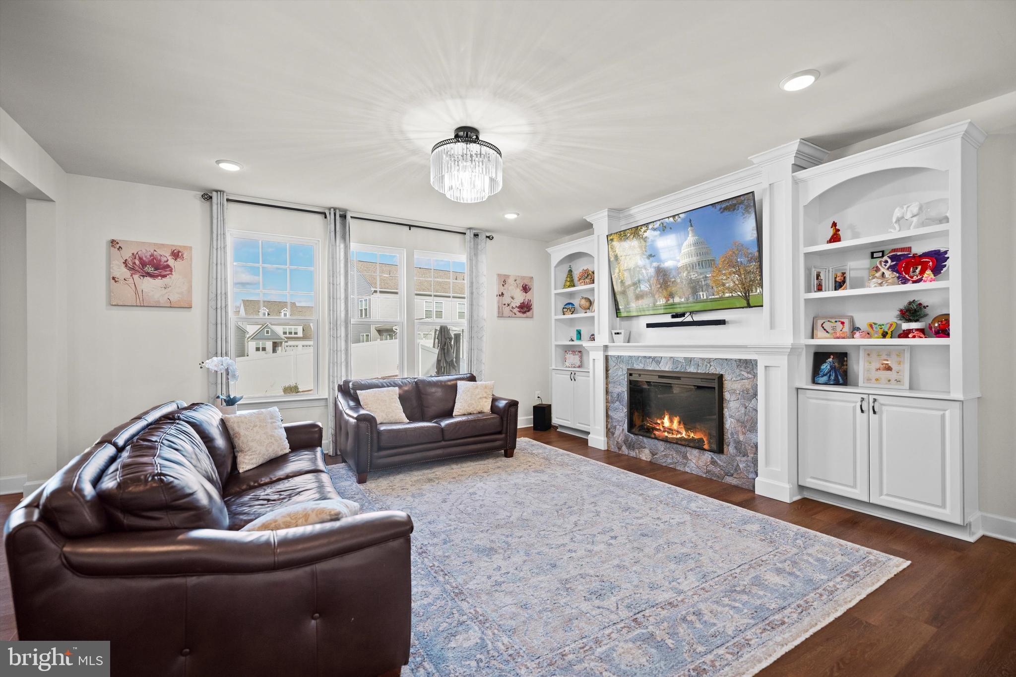 8690 Belle Grove Way Manassas, VA 20110 - Photo 14 of 55 a living room with furniture or flat screen tv and a fireplace