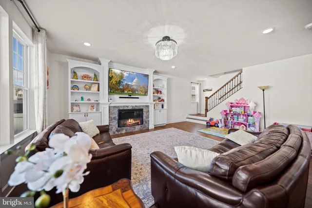 a living room with furniture fireplace and flat screen tv