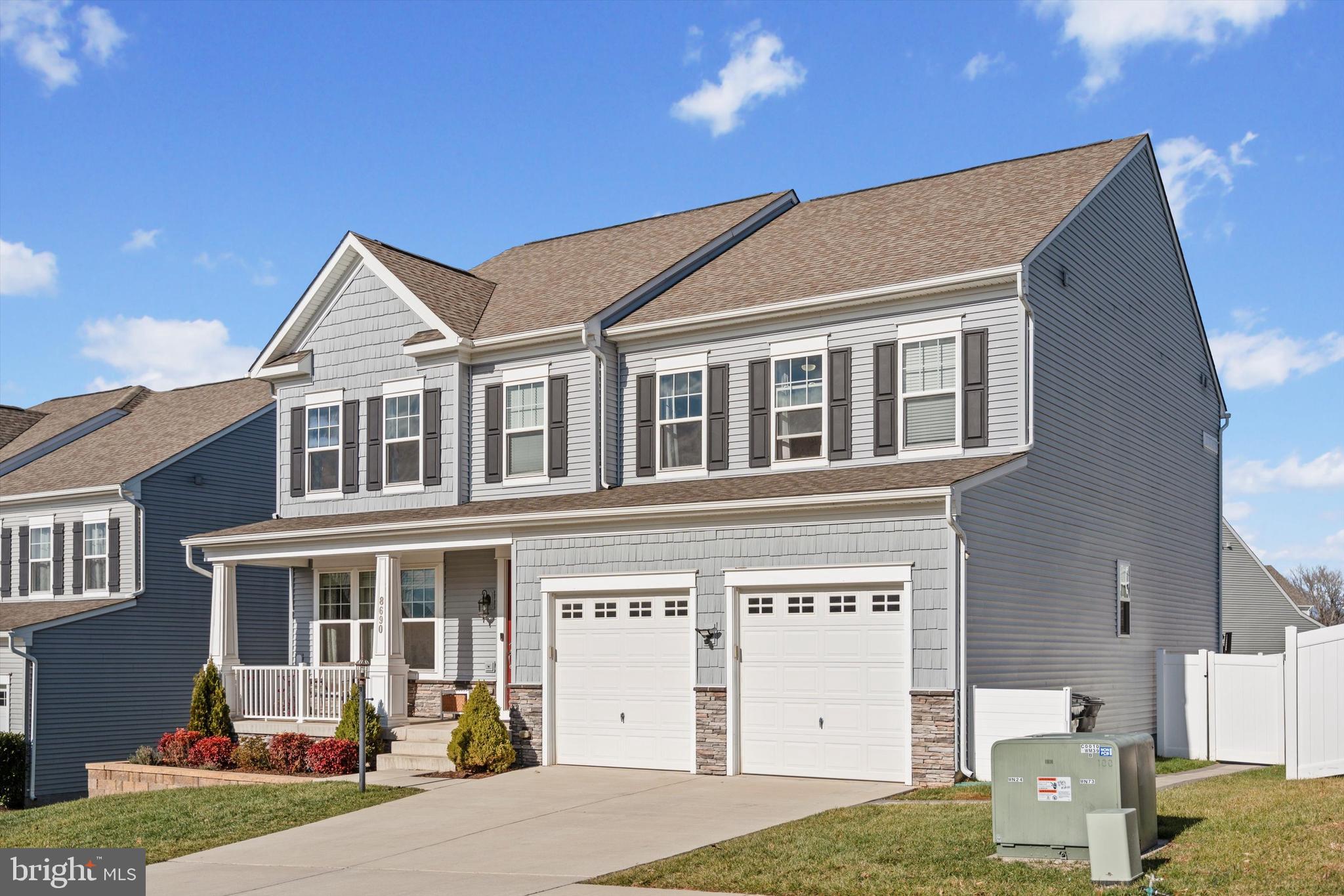 8690 Belle Grove Way Manassas, VA 20110 - Photo 2 of 55 a front view of a building with a garden and entryway
