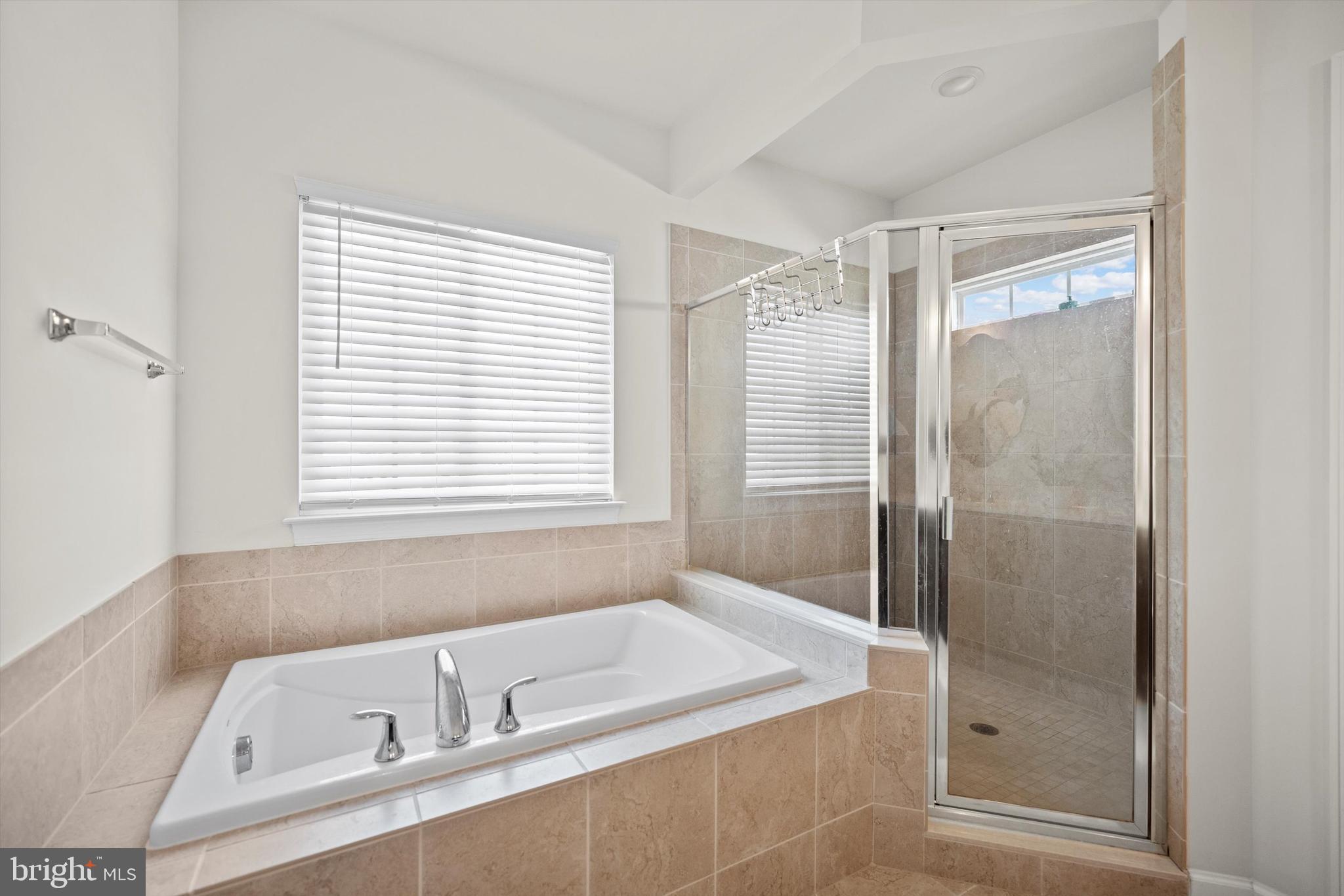 8690 Belle Grove Way Manassas, VA 20110 - Photo 21 of 55 a bathroom with a bathtub and a shower