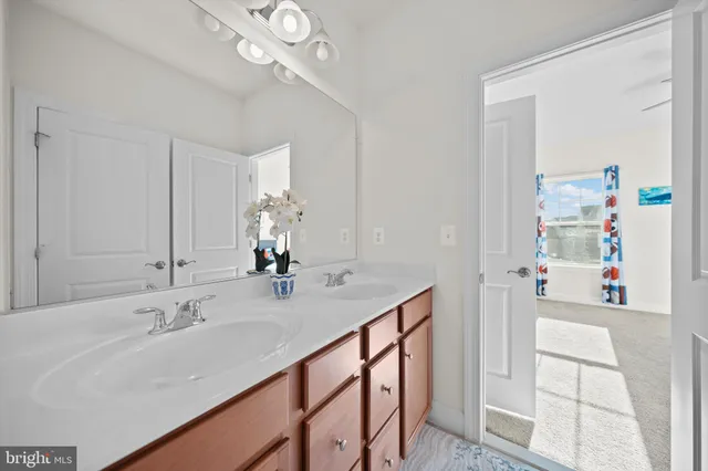 a bathroom with a sink vanity and a mirror