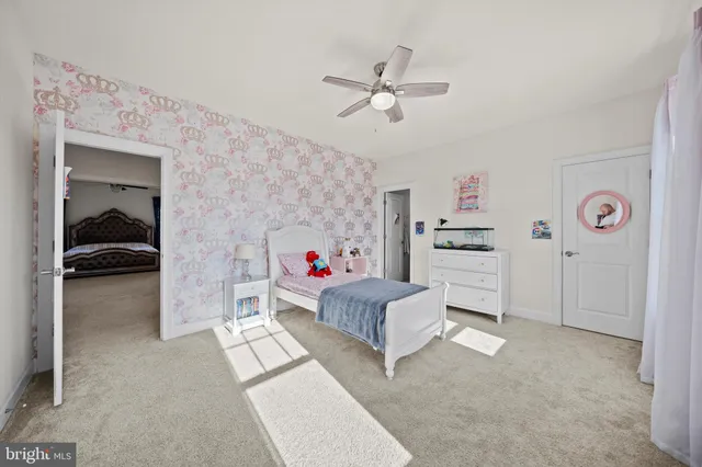 a living room with furniture and a baby crib