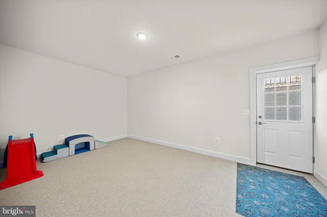 a view of a house with a big yard and large trees
