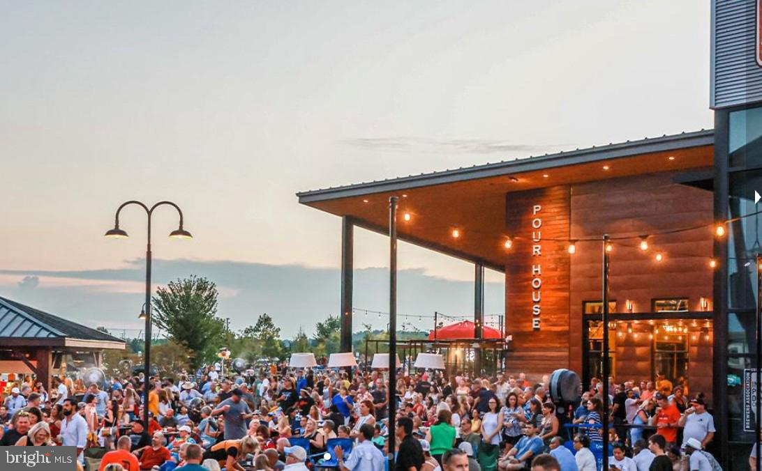 8690 Belle Grove Way Manassas, VA 20110 - Photo 50 of 55 a group of people sitting in front of a store
