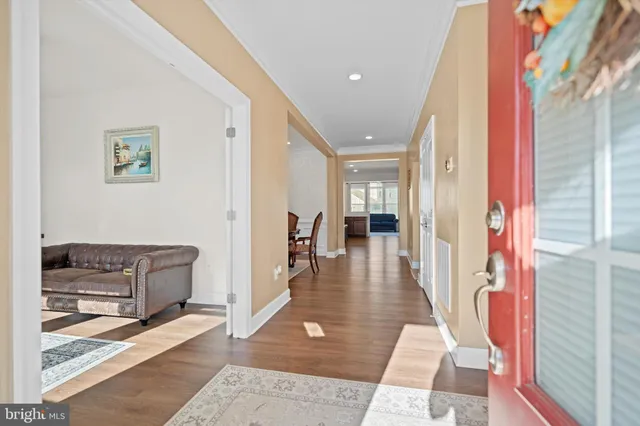 a hallway with furniture and wooden floor