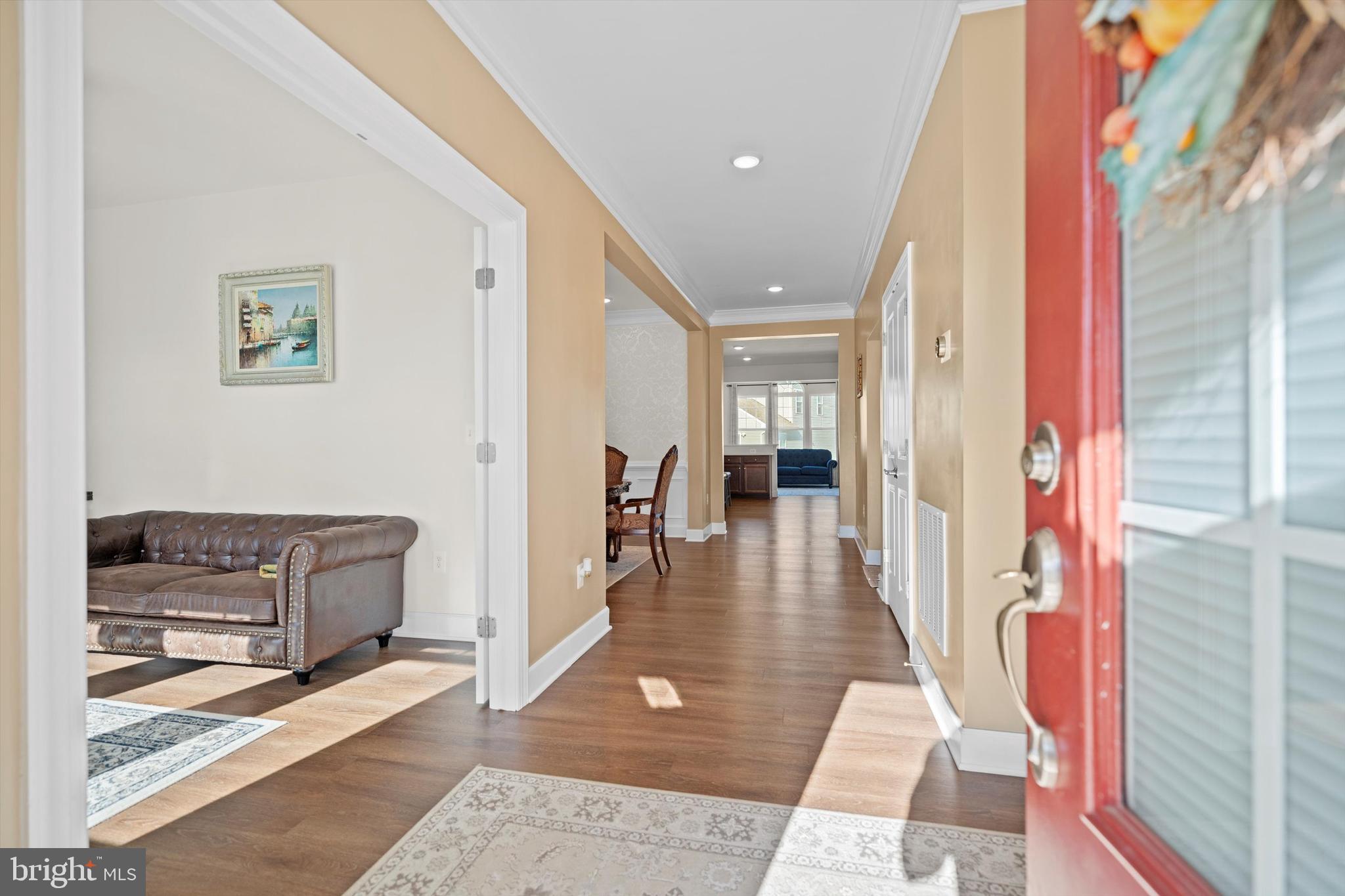 8690 Belle Grove Way Manassas, VA 20110 - Photo 5 of 55 a hallway with furniture and wooden floor