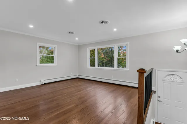 wooden floor in an empty room with a window