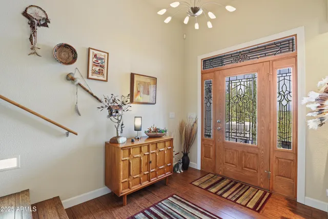 a kitchen with stainless steel appliances granite countertop a sink a stove and a wooden floors