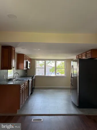 a kitchen with stainless steel appliances a stove a refrigerator and a sink