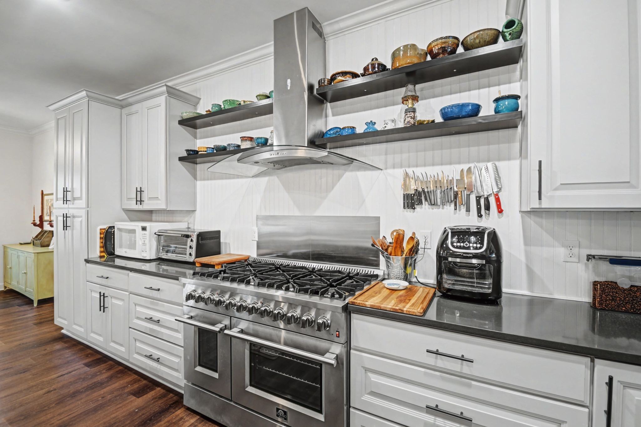 765 Scenic Circle Pulaski, TN 38478 - Photo 11 of 46 a kitchen with stainless steel appliances granite countertop a stove and white cabinets