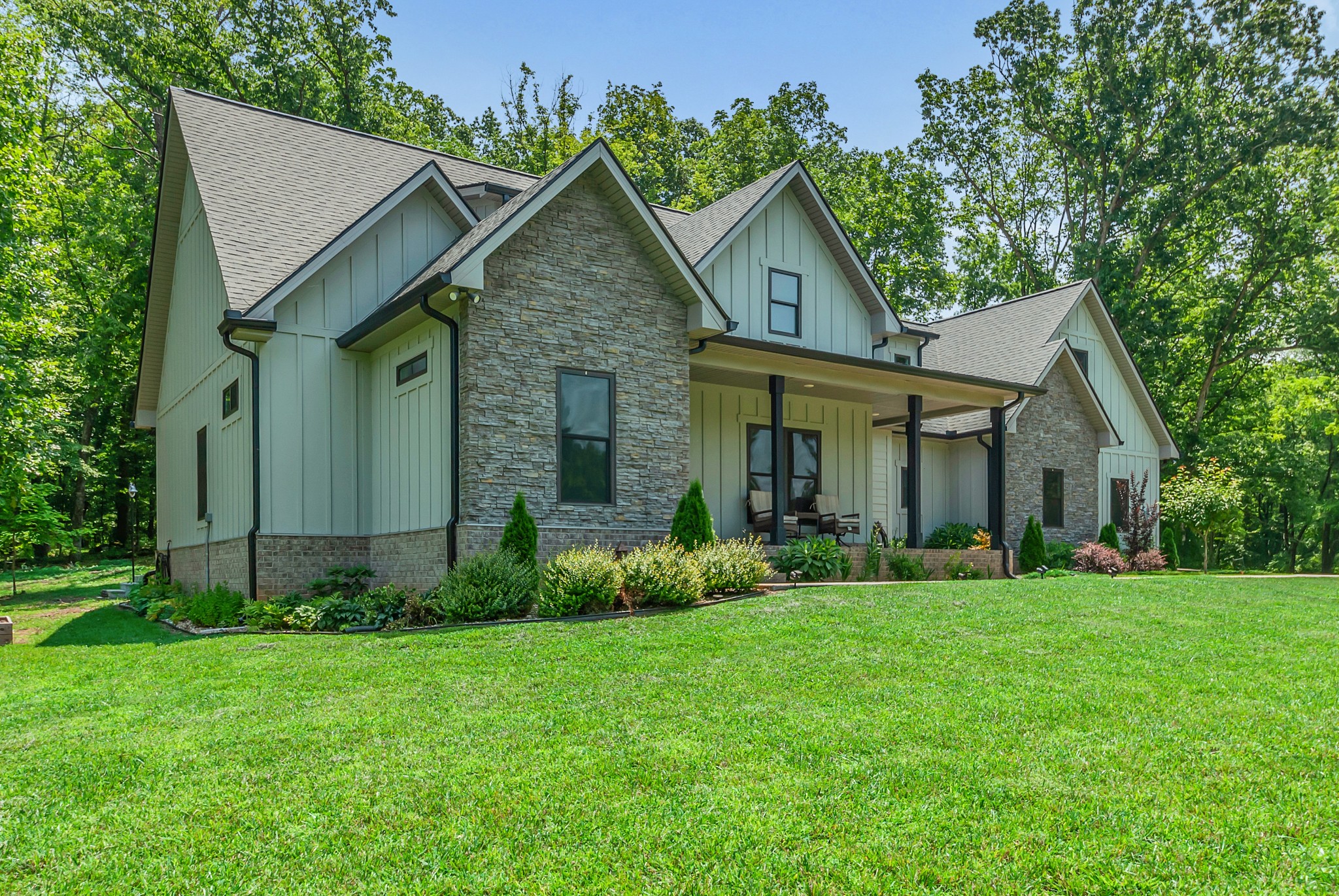 765 Scenic Circle Pulaski, TN 38478 - Photo 2 of 46 a view of a brick house with a big yard and potted plants