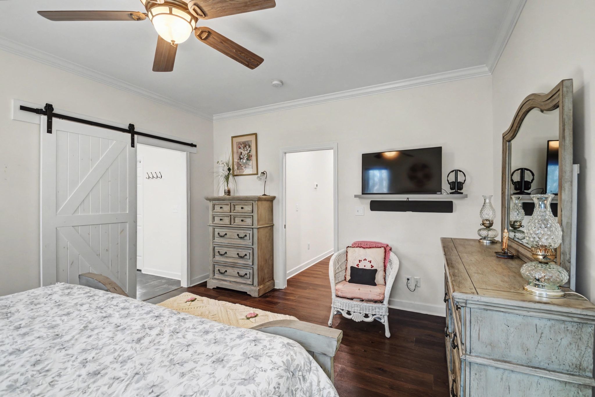 765 Scenic Circle Pulaski, TN 38478 - Photo 33 of 46 a bedroom with a bed flat screen tv and a chandelier