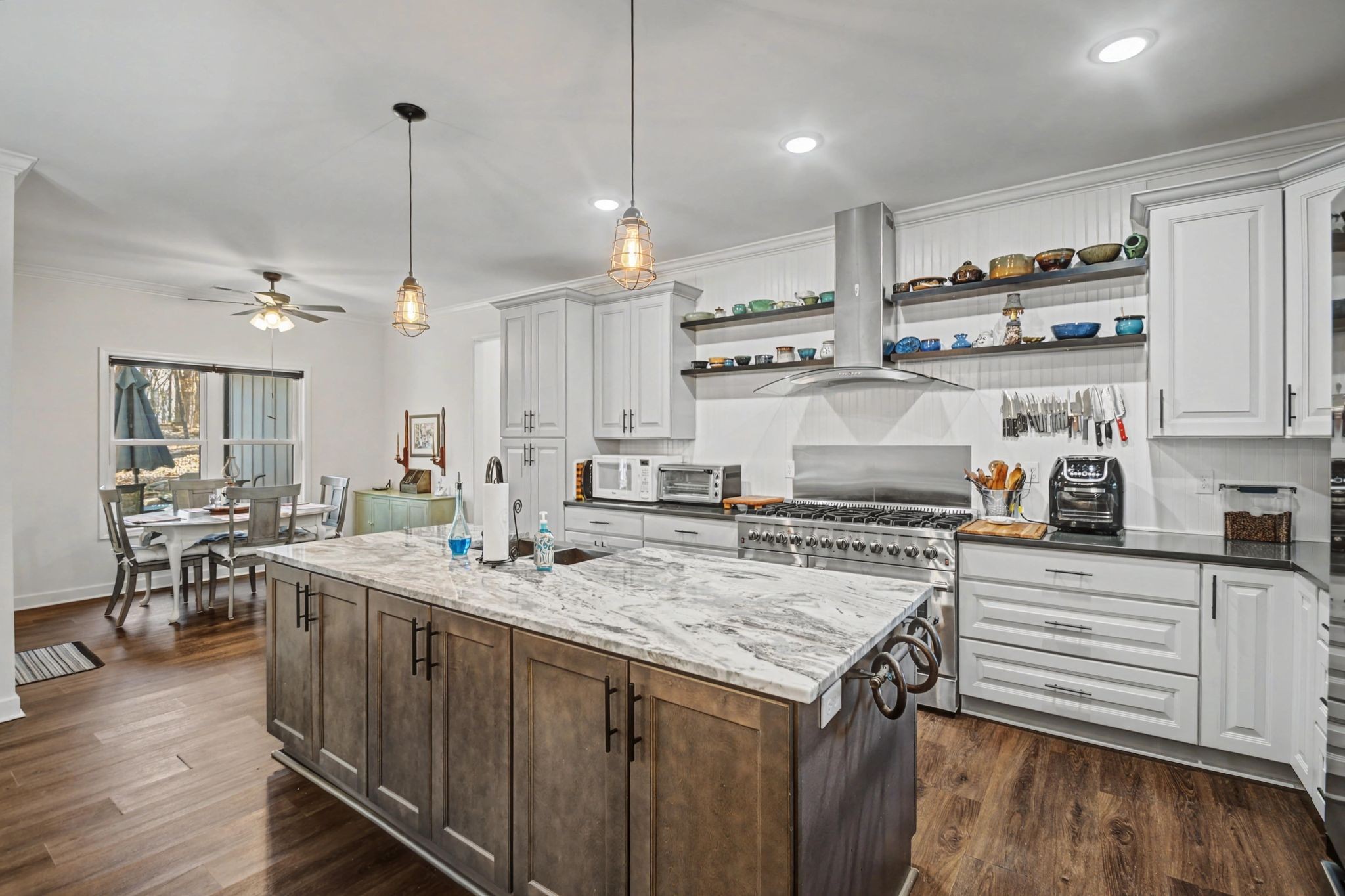 765 Scenic Circle Pulaski, TN 38478 - Photo 9 of 46 a kitchen with kitchen island a stove a sink a center island and wooden floor