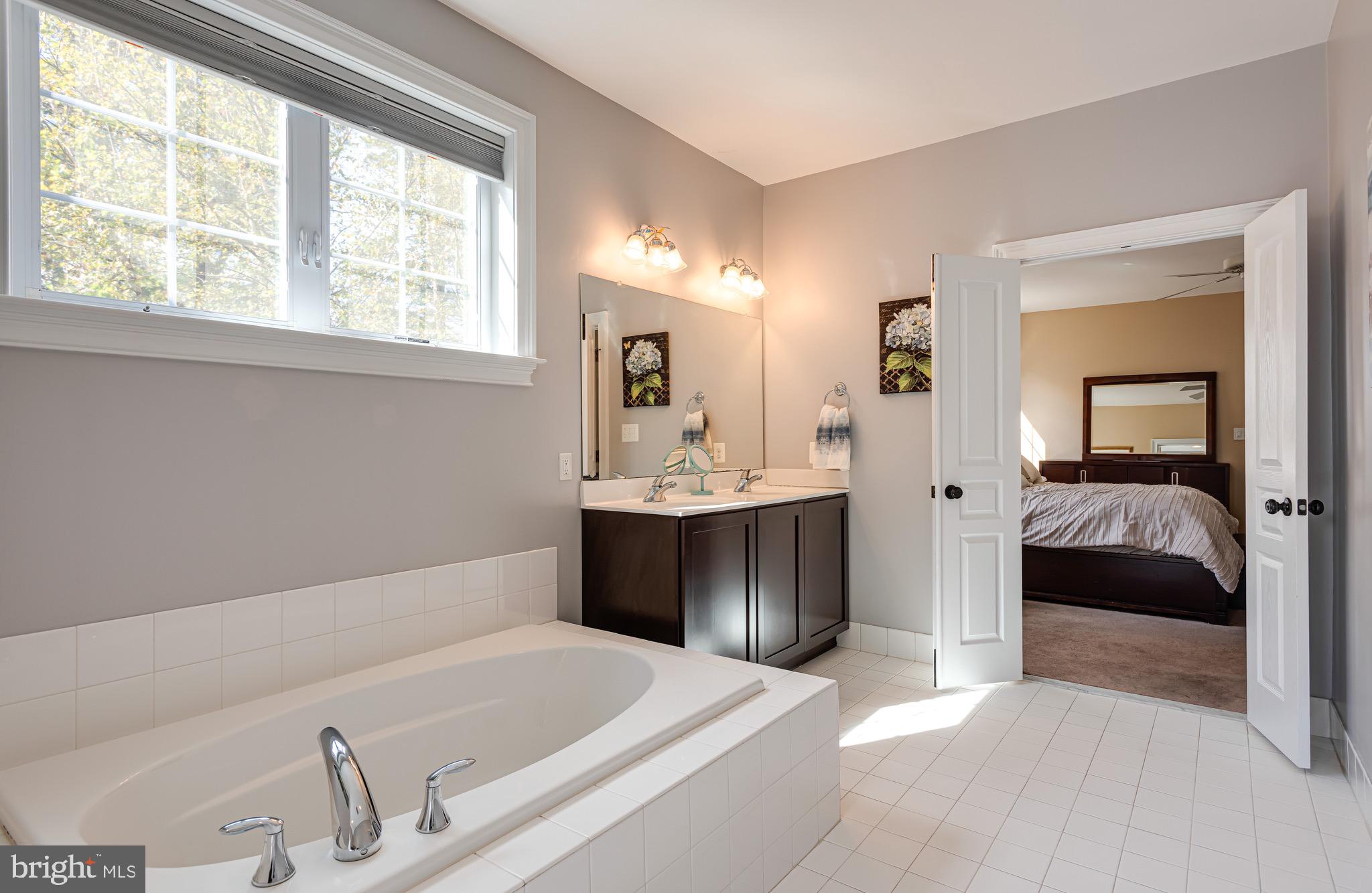 110 Dauphin Drive Springfield, PA 19064 - Photo 24 of 52 a en suite bathroom with a tub sink and mirror