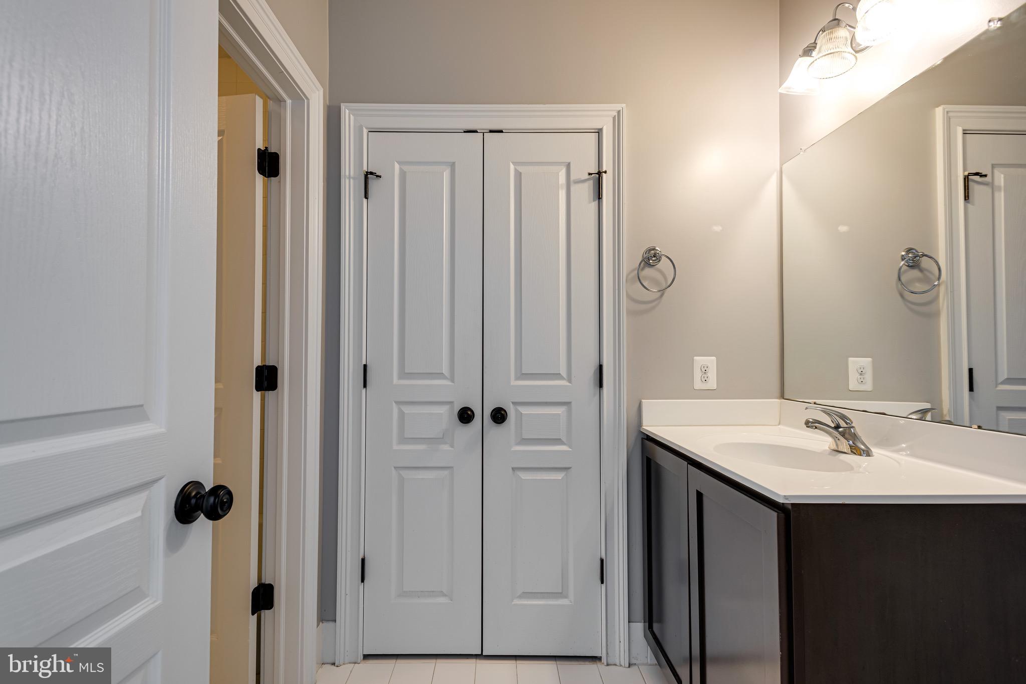 110 Dauphin Drive Springfield, PA 19064 - Photo 32 of 52 a bathroom with a sink and a mirror