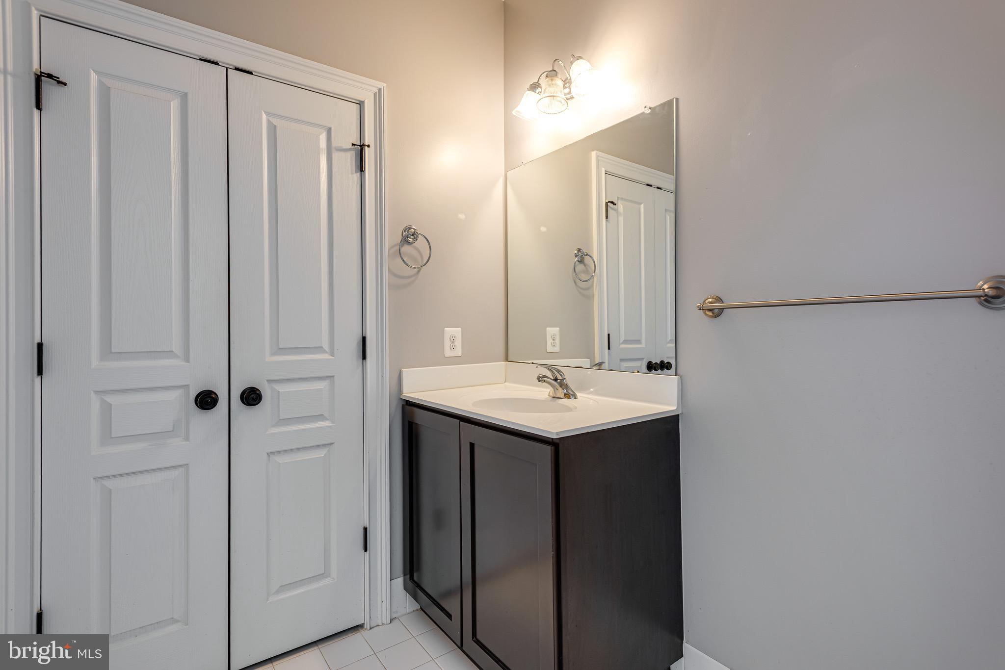 110 Dauphin Drive Springfield, PA 19064 - Photo 34 of 52 a bathroom with a sink and mirror