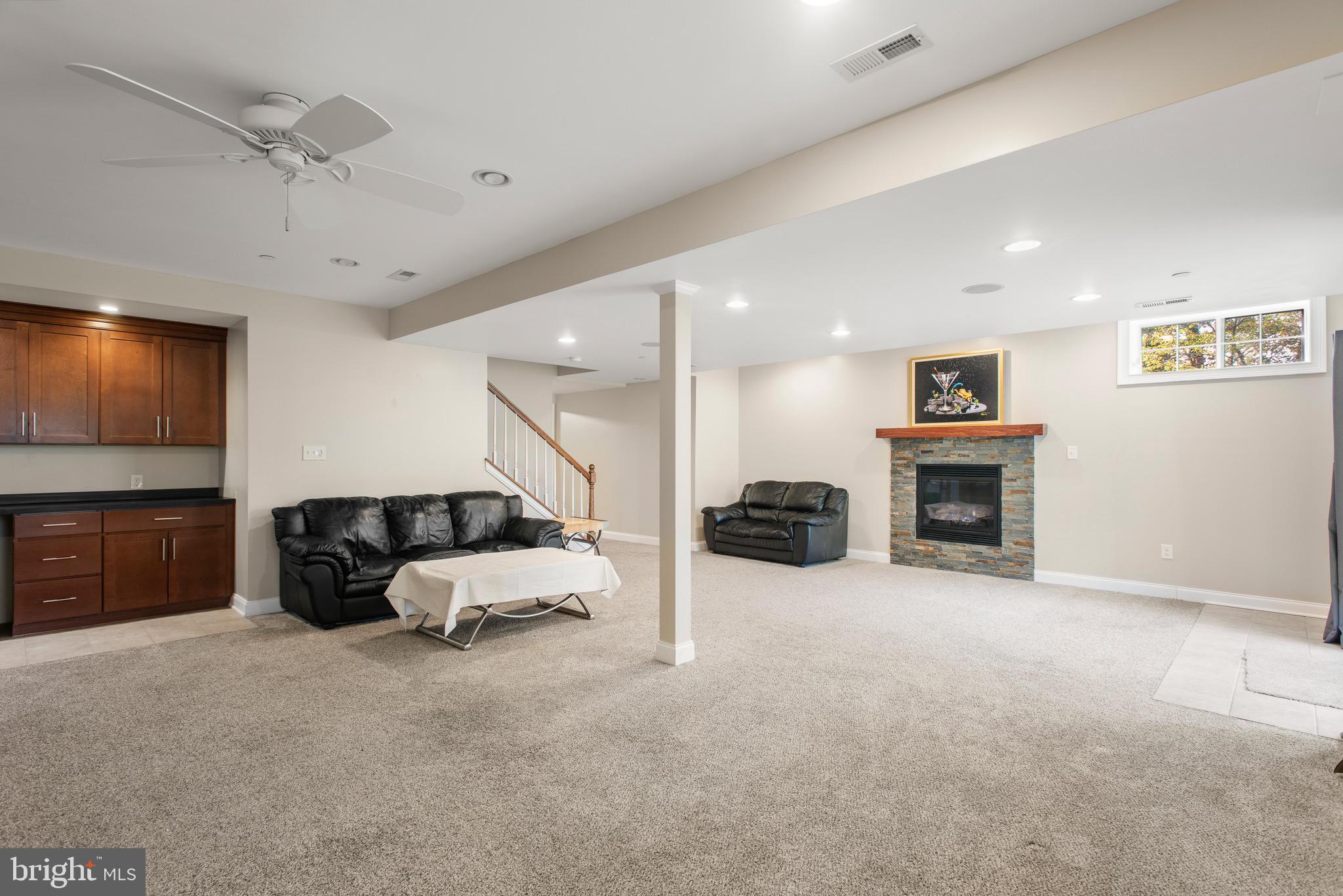 110 Dauphin Drive Springfield, PA 19064 - Photo 36 of 52 a living room with furniture and a fireplace