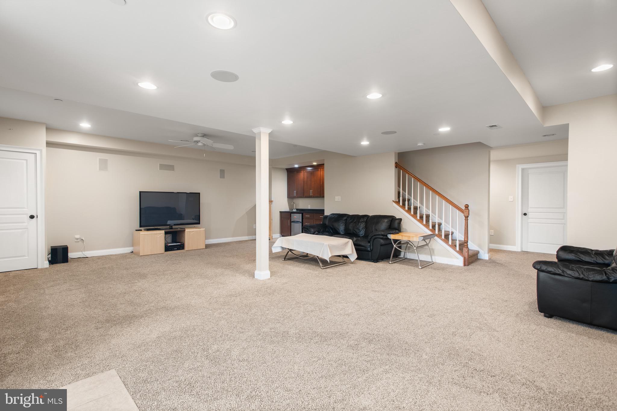 110 Dauphin Drive Springfield, PA 19064 - Photo 37 of 52 a large room with furniture and a flat screen tv