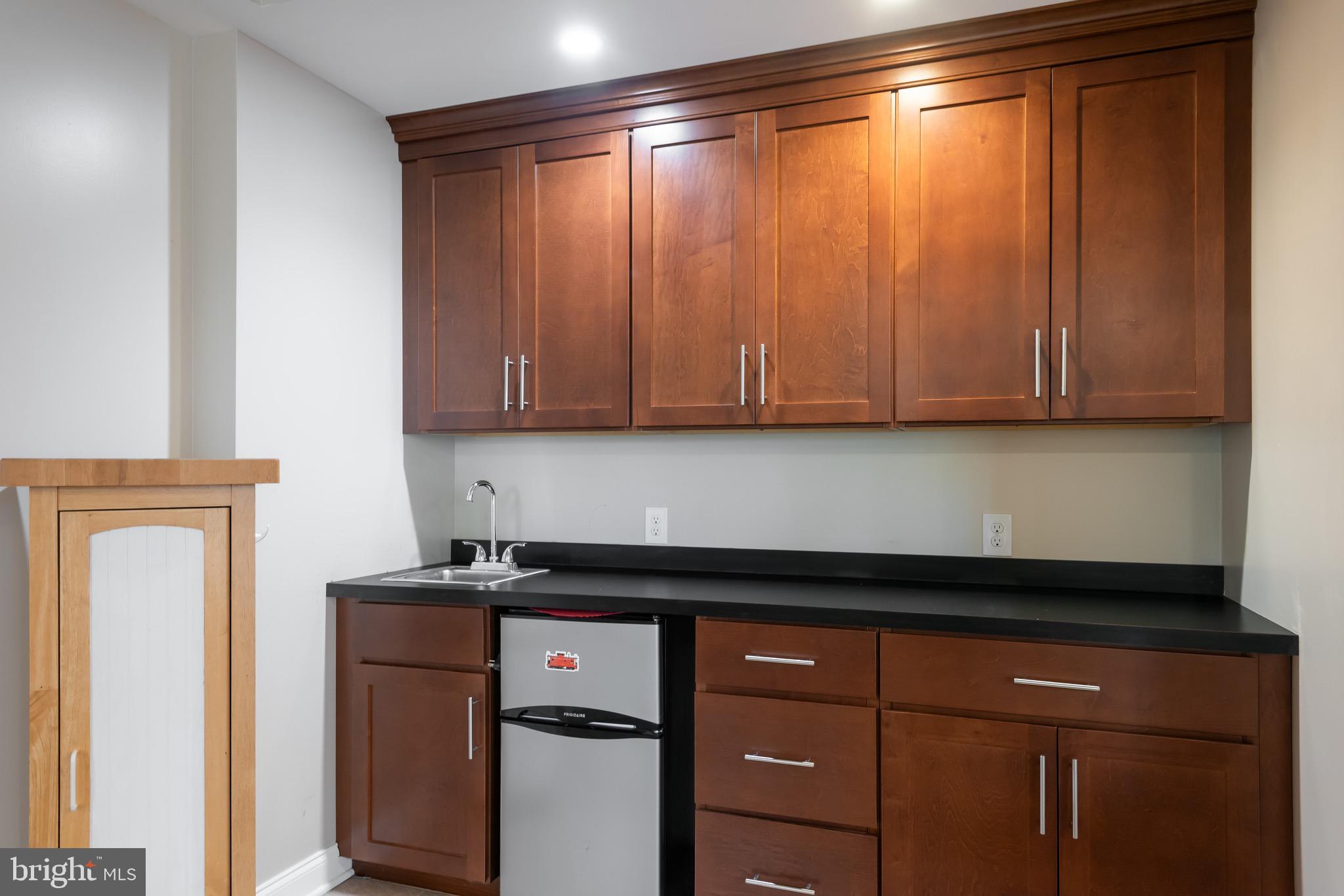 110 Dauphin Drive Springfield, PA 19064 - Photo 39 of 52 a kitchen with a refrigerator and cabinets