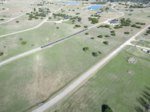 an aerial view of a house with yard