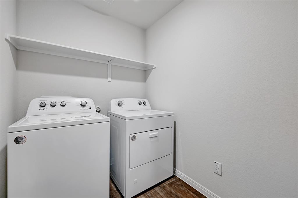 295 Evergreen Sumac Loop Kyle, TX 78640 - Photo 20 of 30 Laundry room featuring washer and clothes dryer and dark wood finished floors