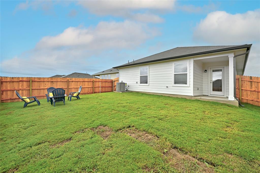 295 Evergreen Sumac Loop Kyle, TX 78640 - Photo 22 of 30 Back of house with a fenced backyard and a patio area