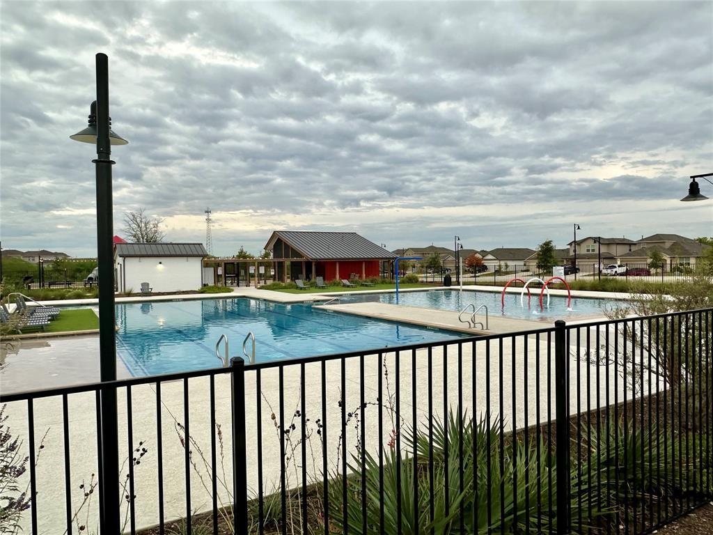 295 Evergreen Sumac Loop Kyle, TX 78640 - Photo 26 of 30 Community pool featuring a patio area