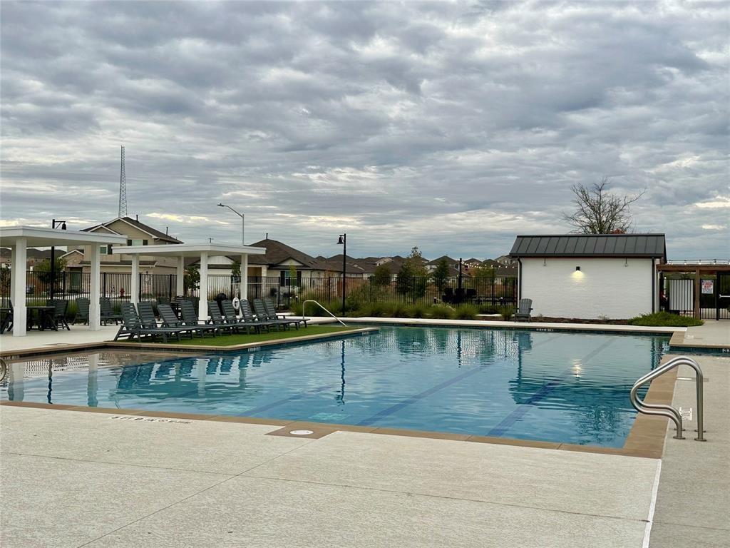 295 Evergreen Sumac Loop Kyle, TX 78640 - Photo 28 of 30 Community pool with a patio area
