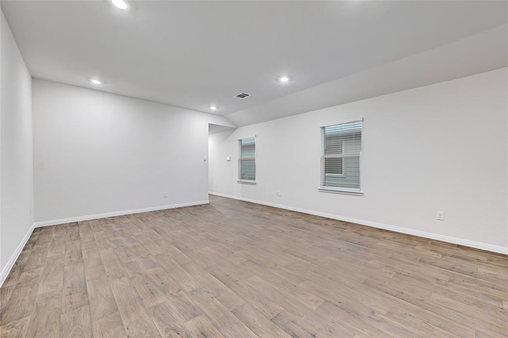 295 Evergreen Sumac Loop Kyle, TX 78640 - Photo 7 of 30 Empty room with light wood-type flooring and recessed lighting
