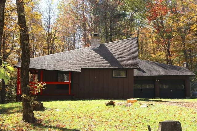 a view of a house with a yard porch and sitting area