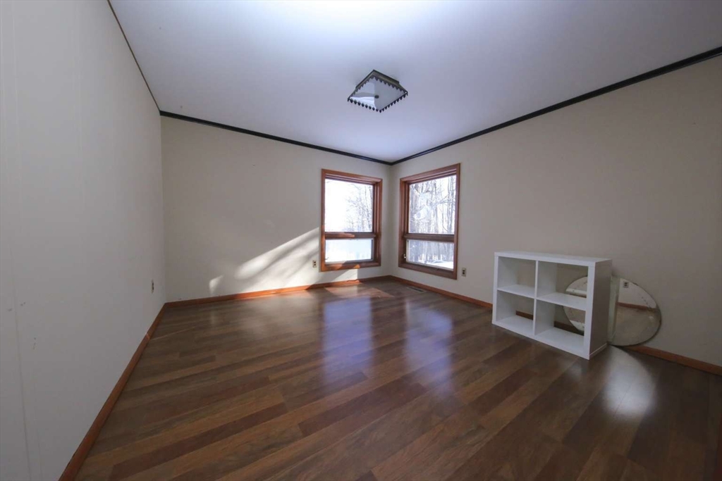 8 Thayer Road Monroe, MA 01247 - Photo 19 of 40 a view of an empty room with wooden floor and a window