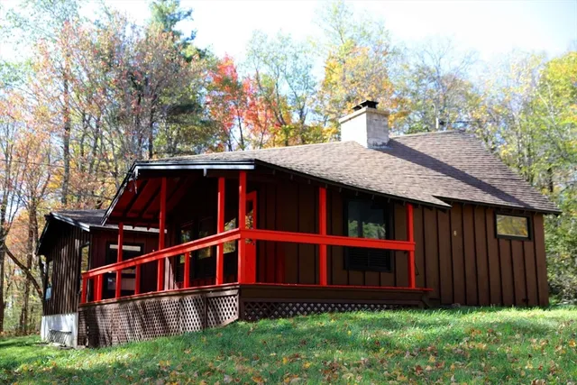 a view of a house with a wooden fence