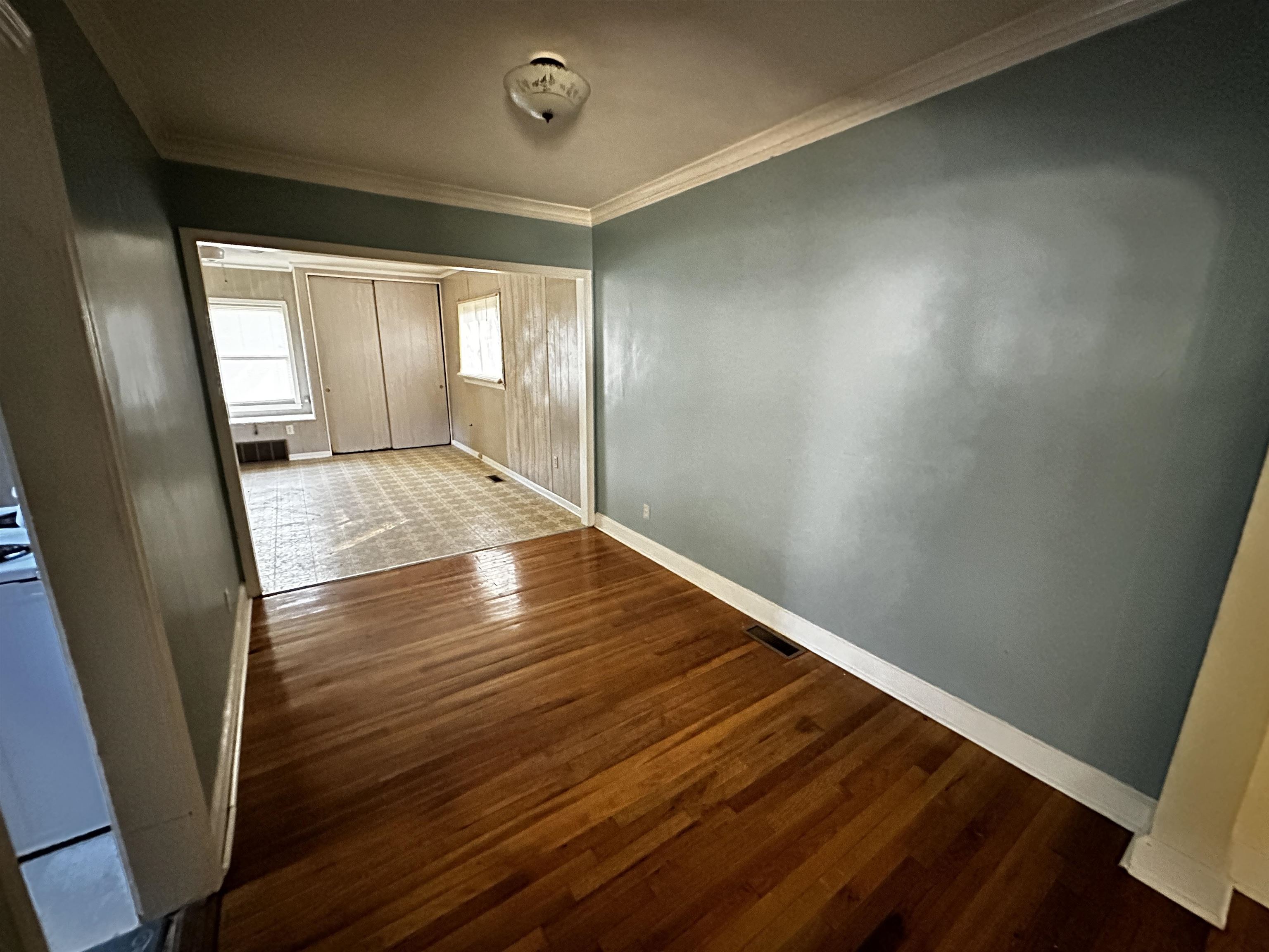 1040 Mt Vernon Road Memphis, TN 38111 - Photo 8 of 16 a view of an empty room with wooden floor and a window