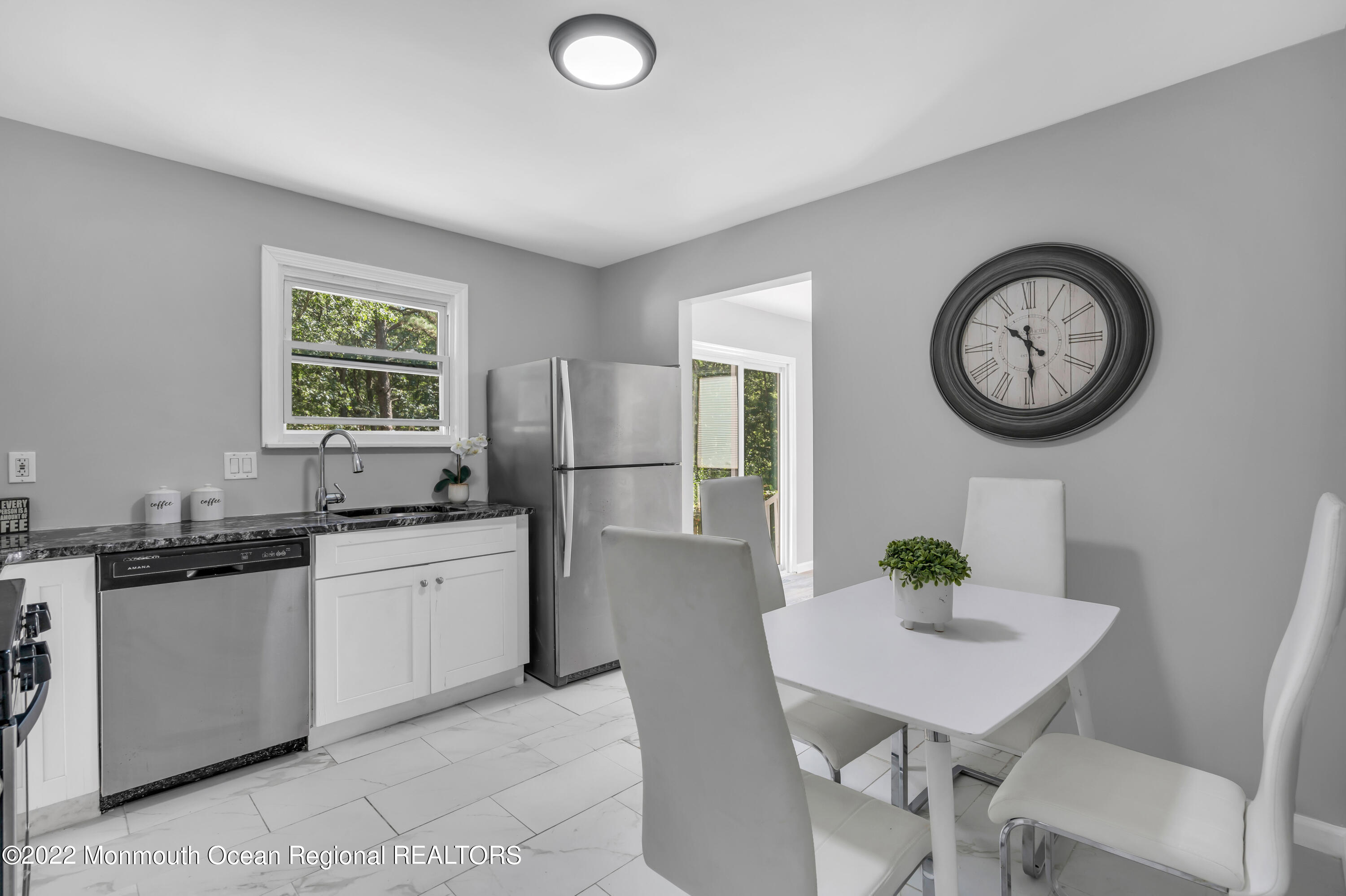 2440 Steiner Road Manchester Township, NJ 08759 - Photo 29 of 59 a kitchen with stainless steel appliances granite countertop a sink a stove a refrigerator a dining table and chairs
