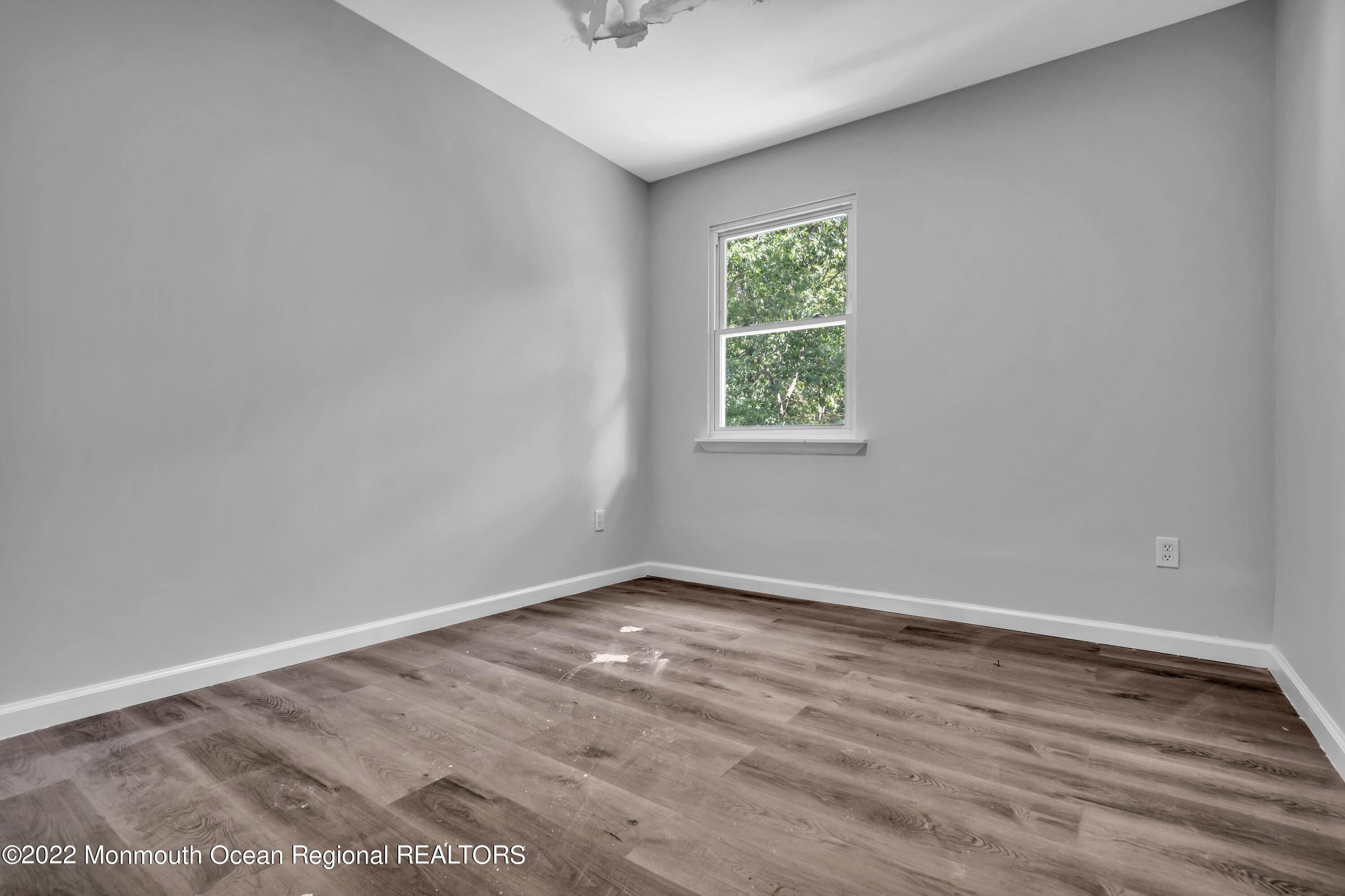 2440 Steiner Road Manchester Township, NJ 08759 - Photo 45 of 59 an empty room with wooden floor and windows