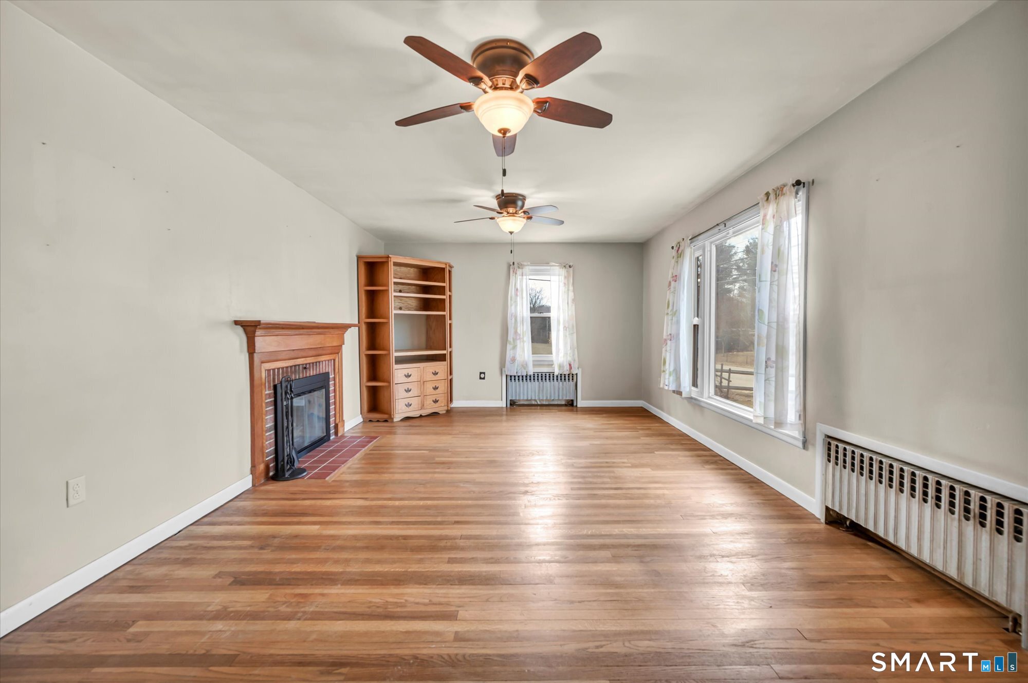 73 Sterling Hill Road Plainfield, CT 06354 - Photo 17 of 35 a view of an empty room with a window and wooden floor