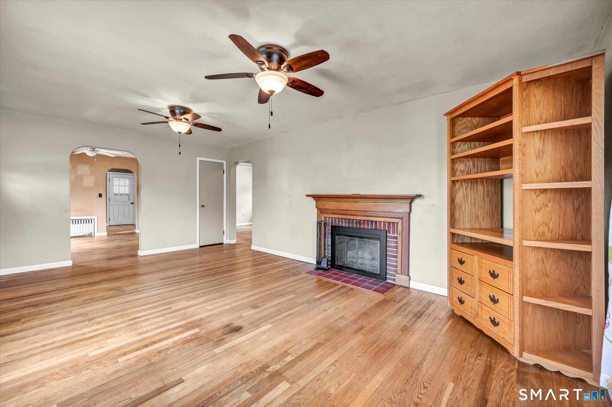 73 Sterling Hill Road Plainfield, CT 06354 - Photo 20 of 35 an empty room with wooden floor fireplace and windows