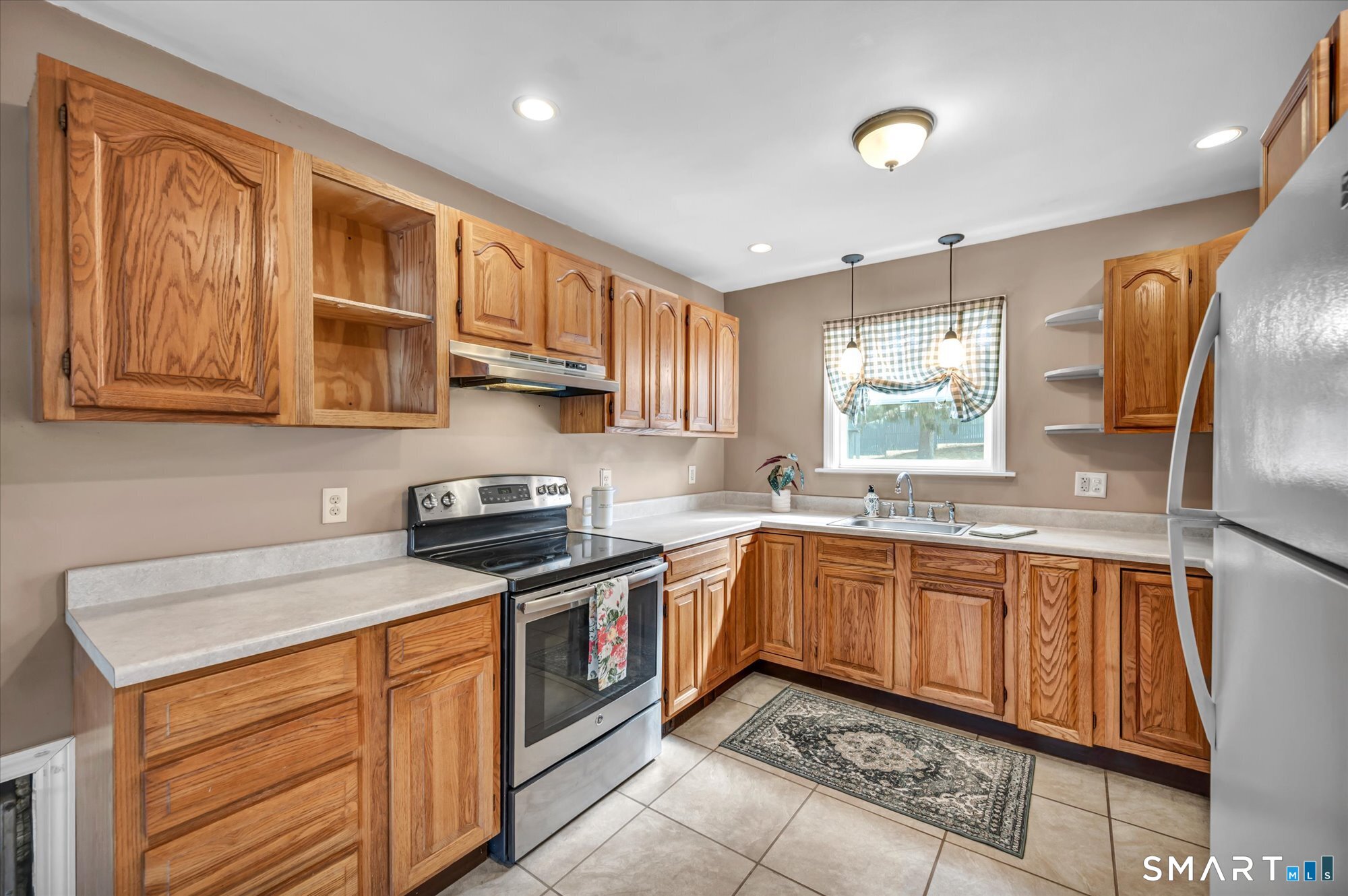 73 Sterling Hill Road Plainfield, CT 06354 - Photo 10 of 35 a kitchen with stainless steel appliances granite countertop wooden cabinets a stove a sink and a large window