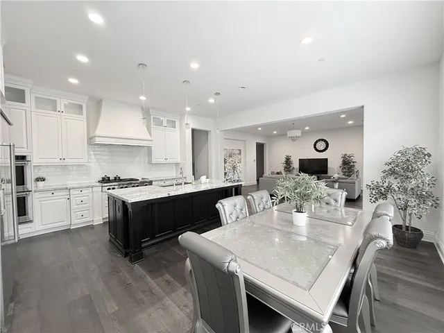 a large kitchen with a table and chairs