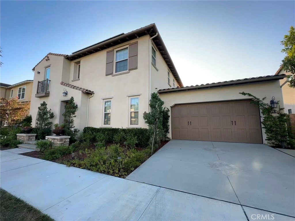 18 Meadow Place Tustin, CA 92782 - Photo 4 of 4 a front view of a house with a yard and garage