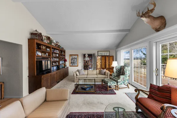 a living room with furniture and a book shelf