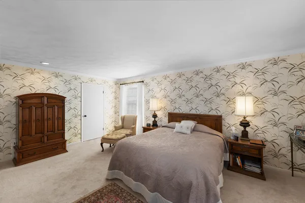 a bed room with a bed and a chair