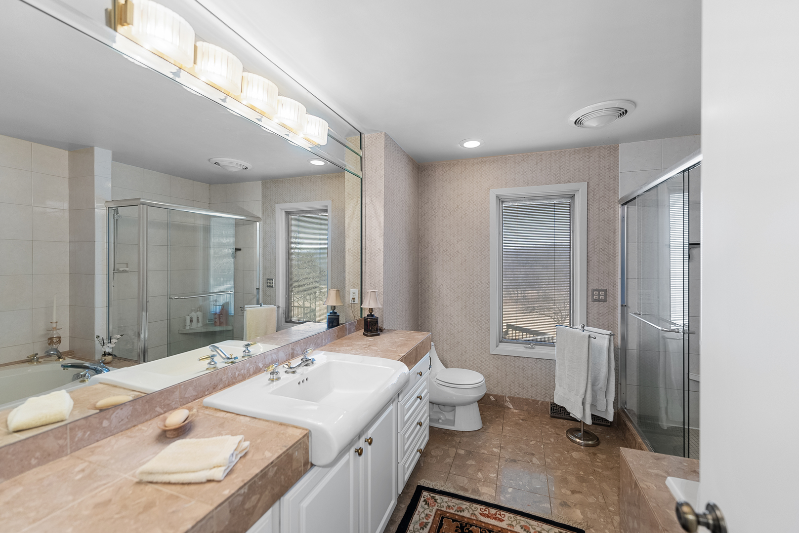6026 95th Avenue West Taylor Ridge, IL 61284 - Photo 20 of 37 a bathroom with a granite countertop sink a toilet a mirror and shower