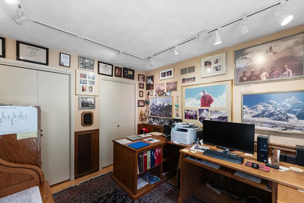 a room with furniture and screen on the wall
