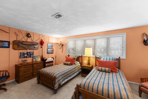 a bedroom with furniture and a window