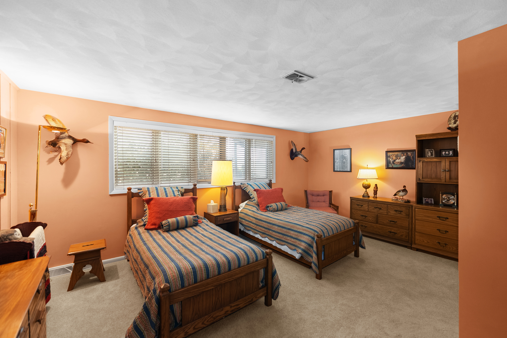 6026 95th Avenue West Taylor Ridge, IL 61284 - Photo 26 of 37 a bedroom with two beds and a dresser next to a window