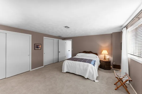 a bedroom with a bed and a table in it