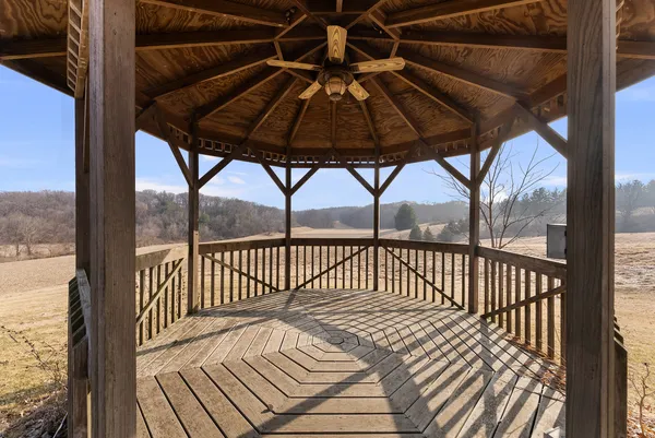 a view of a balcony with a couple of chairs and wooden floor